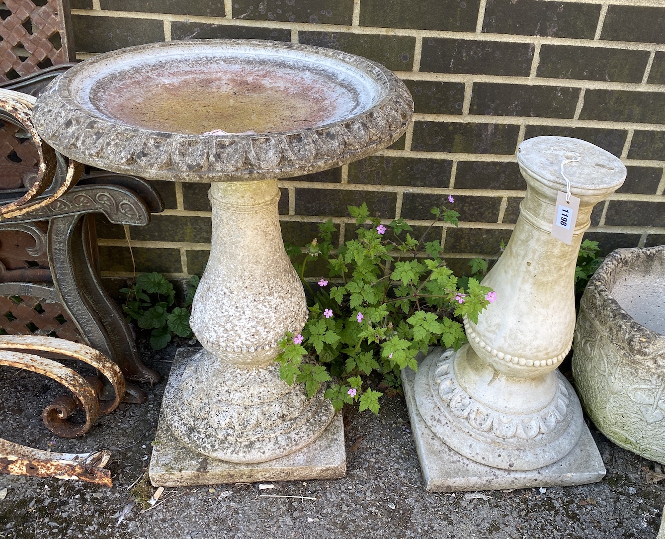 A circular reconstituted stone bird bath, diameter 50cm, height 62cm, together with a faux marble pedestal